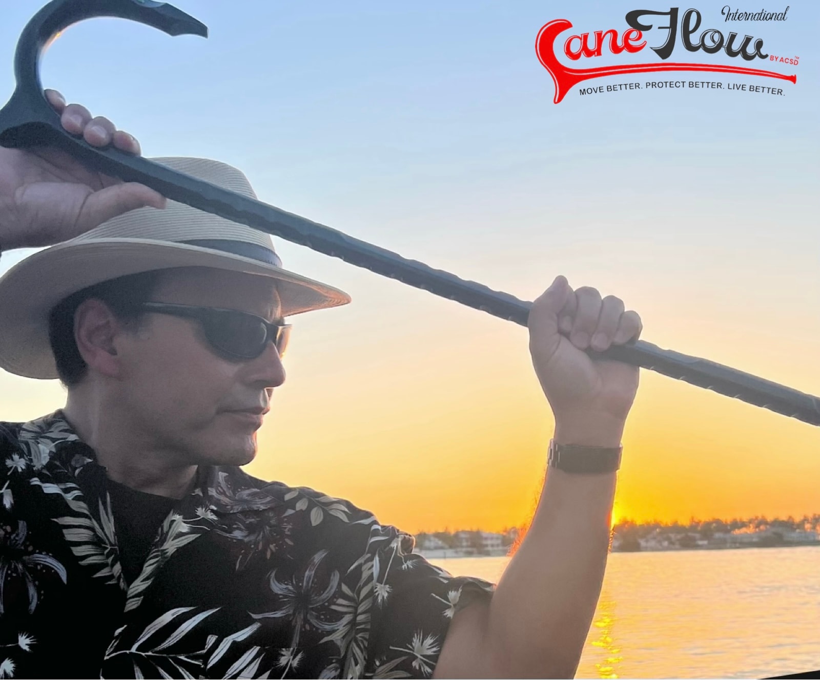 Joe Robaina holding a cane at sunset